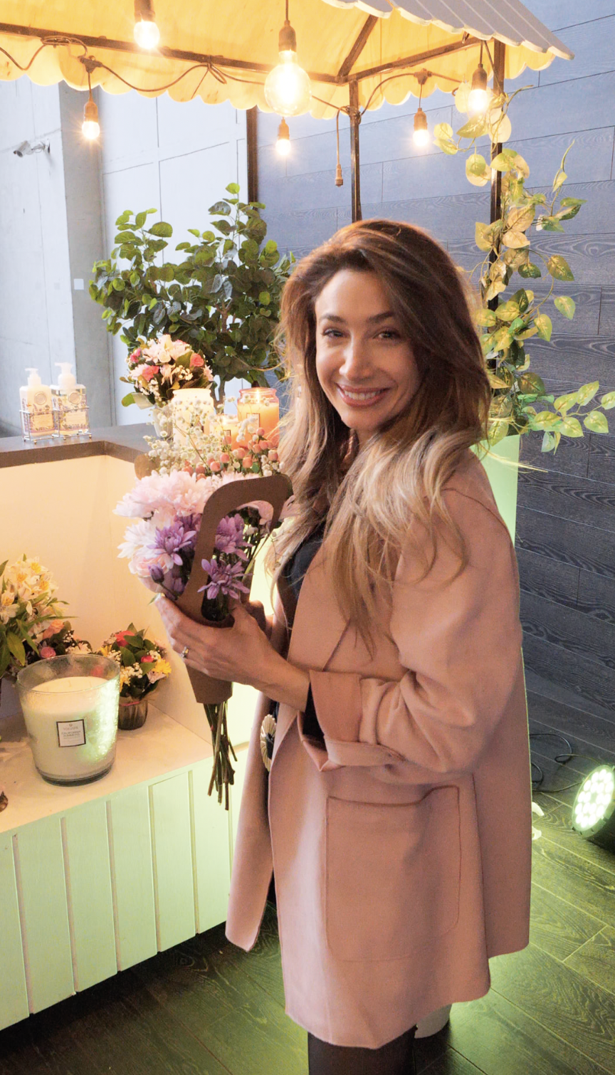 Asistente con su ramo de flores en el rincón floral del evento